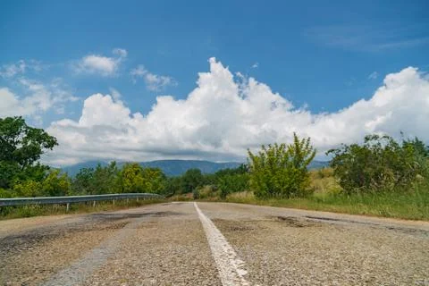 Empty asphalt road with cloudy sky and sunlight Stock Photos