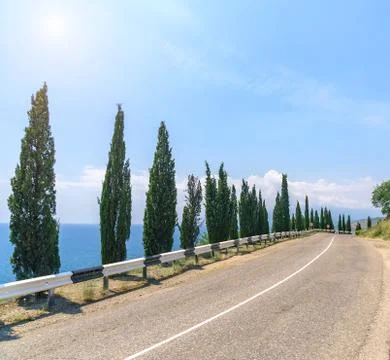 Empty asphalt road with cloudy sky and sunlight Photos
