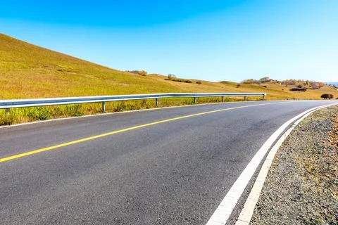 Empty asphalt road ground under blue sky. Stock Photos