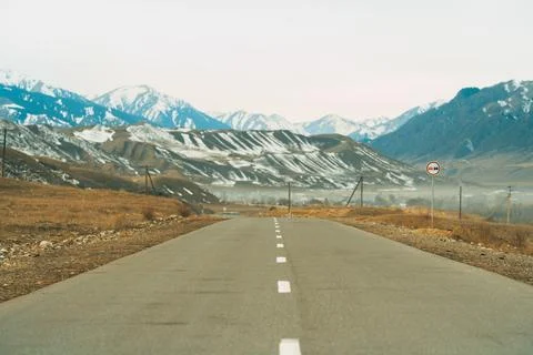 Empty asphalt road with mountains in the background Stock Photos