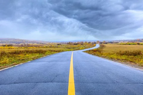 Empty asphalt road pavement and sky clouds on a cloudy day. Stock Photos