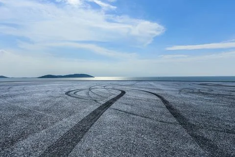 Empty asphalt road platform and lake with mountain background. Stock Photos