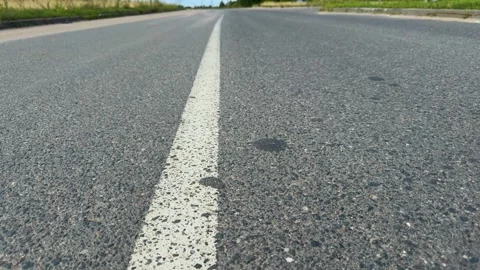 Empty asphalt road with white line marking stretching into distance Stock Footage 340997860