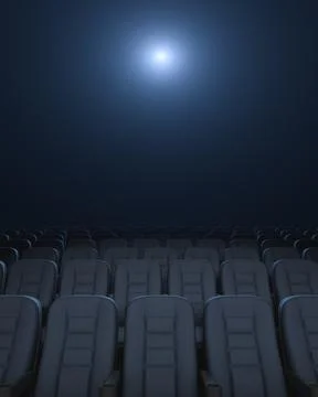 Empty auditorium. Rows of armchairs. Glowing Cinema Projector. Stock Photos