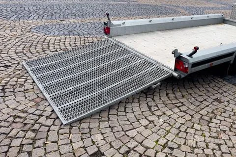 Empty auto trailer with lowered ramp. Ready for loading. Stock Photos