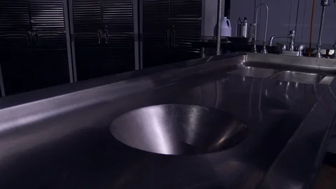 EMPTY AUTOPSY TABLE IN A COLD MORGUE.  4K, 10 BIT SLIDER SHOT. Stock Footage 100200724