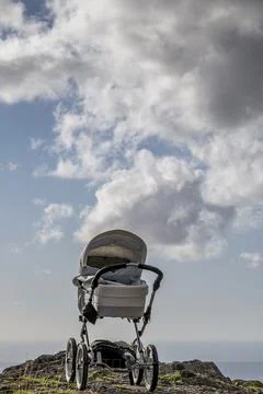 An empty baby stroller is on top of a mountain Stock Photos