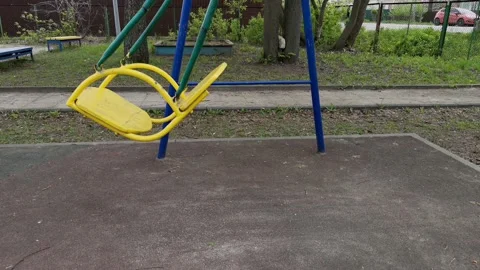 Empty baby swing swing in the playground Stock Footage 154182848