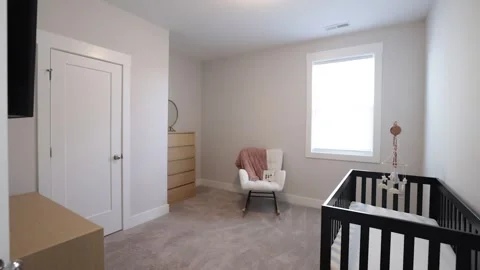 Empty Baby's Room With A Crib And Cute Carpet On The Floor. Large Window Stock Footage 267076705