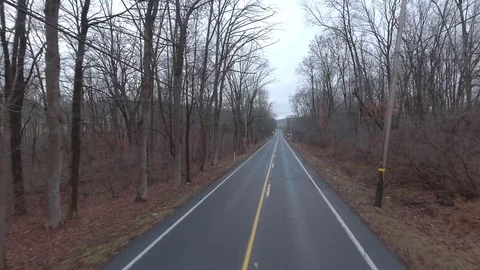 Empty back country road on cloudy day flyover Stock Footage 71759965