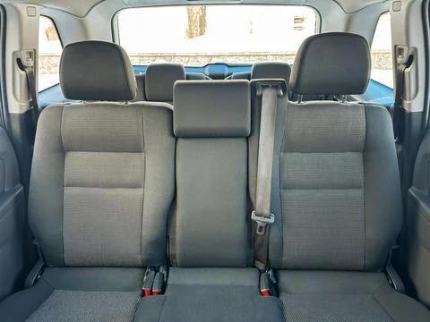 Empty back seat area of a car showing space for passengers and seat belts, .. Stock Photos