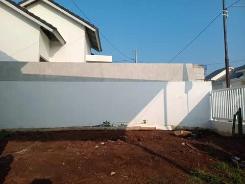 Empty Backyard with White Wall and Clear Sky Stock Photos