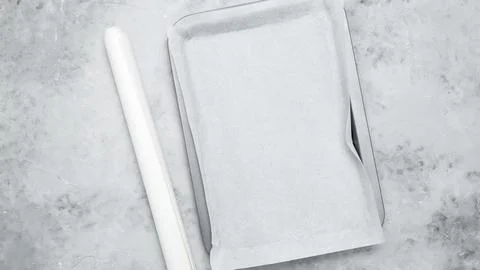 Empty baking tray covered with baking paper Stock Photos