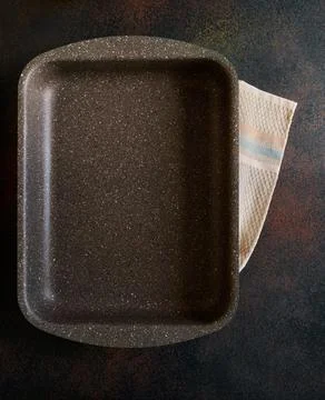 Empty baking tray with non-stick granite coating on dark background Stock Photos