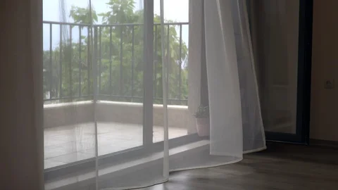 Empty balcony with transparent curtain fluttering in the wind in summer Vídeos de archivo 120308780