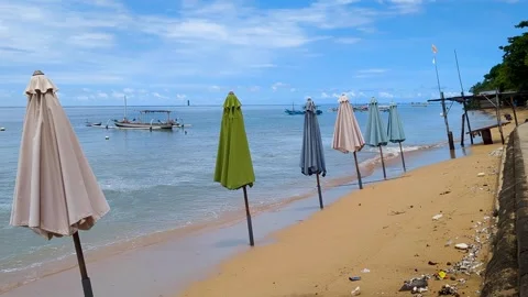 Empty Balinese white sandy beach with no people, sun umbrella parasols in ocean Stock Footage 307946116