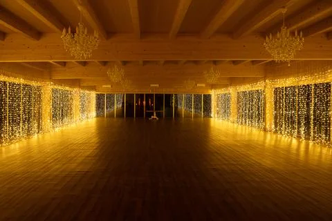 Empty ballroom decorated with string lights for event Stock Photos