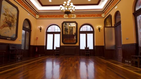 Empty ballroom interior features parquet flooring a chandelier and a large Stock Footage 327452944