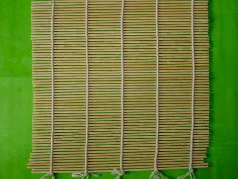 Empty Bamboo Sushi Rolling Mat on Green Background, Sushi Preparation Tool Stock Photos