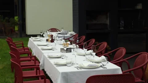 Empty banquet table served for an outdoor dinner party Stock Footage 338343993