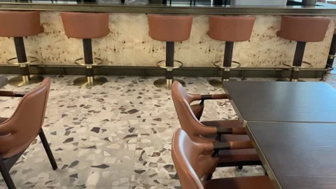 Empty bar interior with brown chairs and terrazzo floor, suitable for resta.. Stock Footage 332064270