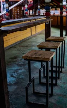 Empty bar stools and table in an empty room Stock Photos