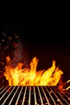 Empty barbecue BBQ grill grid with blurred bright flaming fire and sparks, smoke Stock Photos