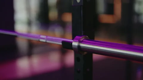 Empty Barbell in Purple-Lit Gym: Fitness and Workout Motivation Видео 311931973