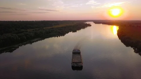 Empty barge floating on the river at sunset, aerial shot Stock Footage 97702906