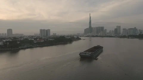 An empty barge slowly floats down the Saigon River Video stock 296592802
