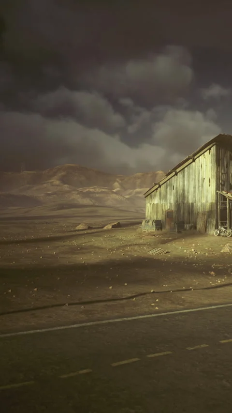 Empty barn in a dry landscape under a cloudy sky at sunset Stock Footage 339940593