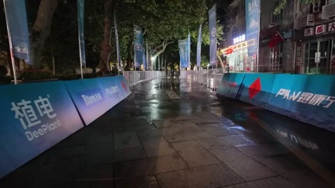 Empty Barrier Lined Wet City Street Reflecting Lights at Night, Lushan Video stock 346701366