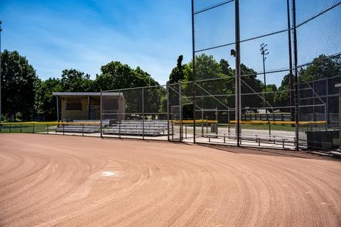 Empty baseball diamond with backstop and bleachers Stock Photos