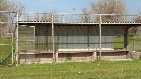 Empty Baseball Dugout with Chain-Link Fencing on Rural Field Stock Footage 342587187