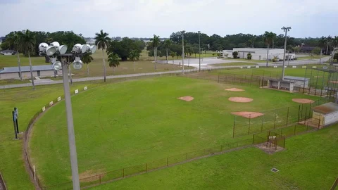 Empty Baseball Fields Due to Coronavirus aerial Lightpost foreground rotate Stock Footage 128672418