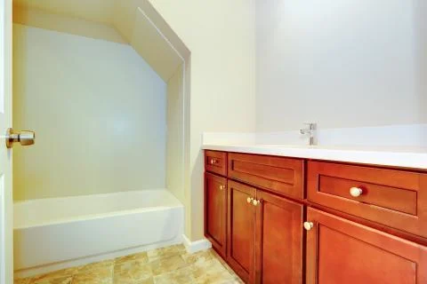 Empty bathroom interior with bright brown vanity cabine Stock Photos