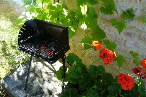 An empty BBQ showing the red hot coals heating up ready to start cooking Stock Photos