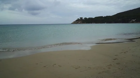 Empty beach and beautiful landscape view on a calm sea and island coast on cl Stock Footage 83386389