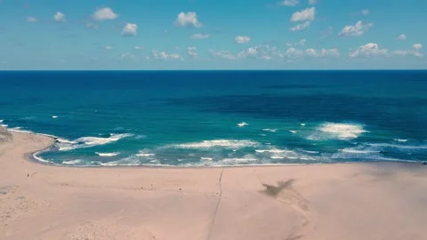 Empty beach and blue wavy sea with clean, shiny sky Stock Footage 138131945