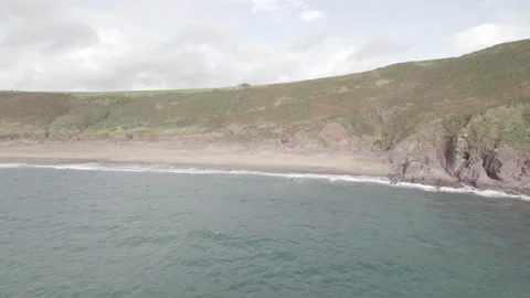 Empty beach and rocky coast washed by waves Video stock 166541790