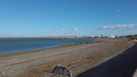 Empty beach and strong winds ocean with factory builidings Stock Footage 107168974