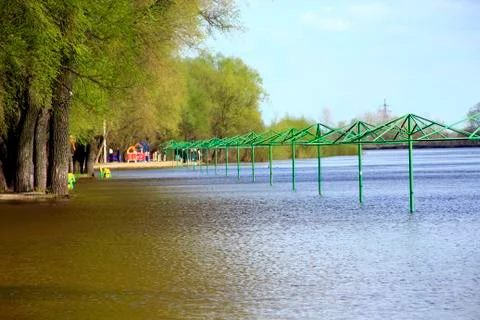 Empty beach awnings flooded with water during flood of spring Stock Photos