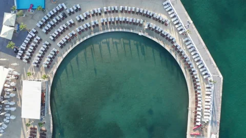 Empty beach beds on the concrete beach - pier or dock lining a small marina Stock Footage 213620533