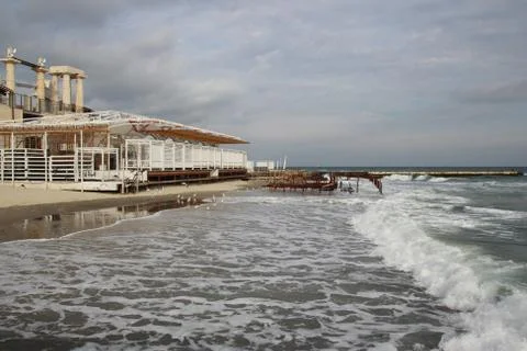 Empty beach of the Black Sea in cloudy autumn weather. Landscape with stormy sea Stock Photos