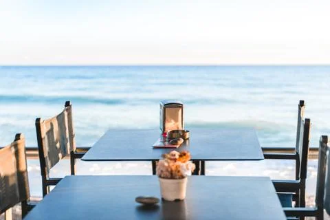 Empty beach cafe without visitor, people. Empty Beach chair, table, bay, seas Stock Photos