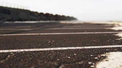 Empty beach car park spaces covered in asphalt. Ilustração Stock
