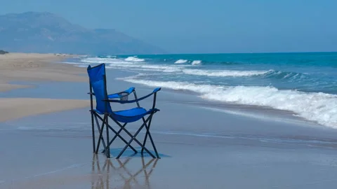 Empty beach chair standing on the coastline Stock Footage 295316764