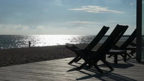 Empty beach chairs in the sunset Video stock 218425958