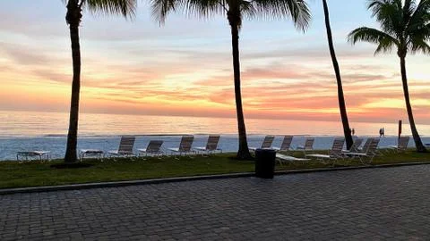 Empty beach chairs at sunset Stock Photos