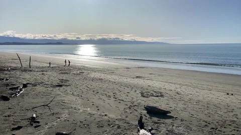 Empty beach with children playing on a sunny clear calm afternoon 库存影片 198910814